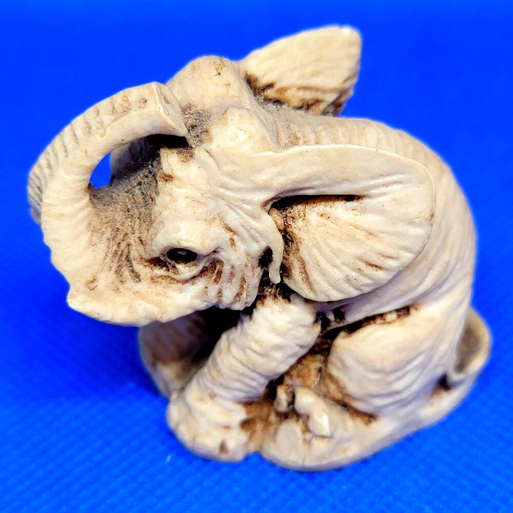 Vintage Miniature 2" Sitting Elephant with Tusks Raised Trunk Figurine No Mark